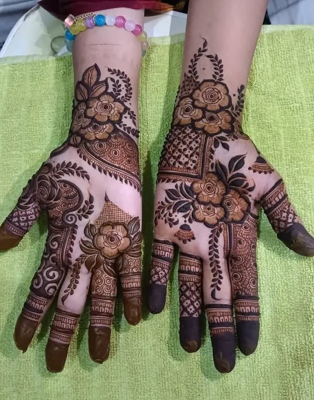 Elegant Arabic and floral mehendi design on hands by Anand Mehendi & Tattoo, Bhubaneswar