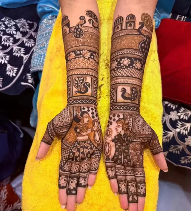 Detailed bridal mehendi design on both arms by Anand Mehendi & Tattoo, Bhubaneswar