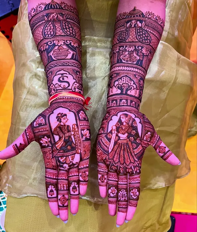 Detailed bridal mehendi design on both arms by Anand Mehendi & Tattoo, Bhubaneswar