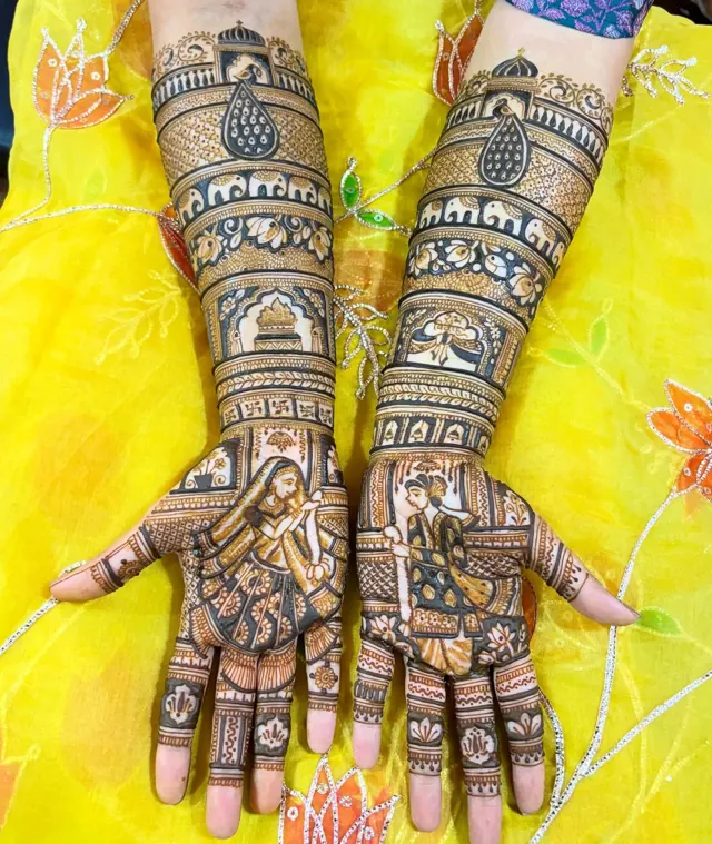 Detailed bridal mehendi design on both arms by Anand Mehendi & Tattoo, Bhubaneswar