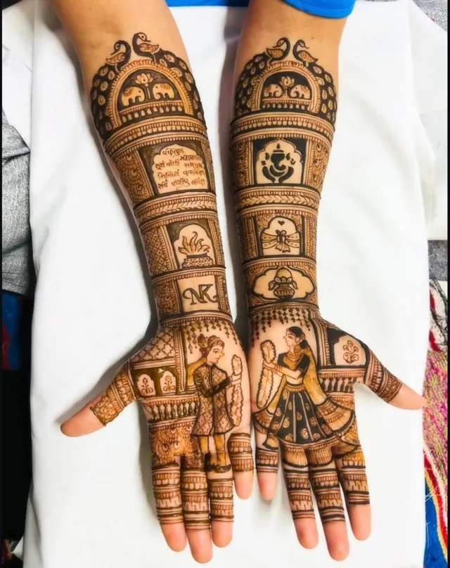 Detailed bridal mehendi design on both arms by Anand Mehendi & Tattoo, Bhubaneswar