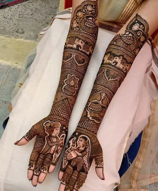 Detailed bridal mehendi design on both arms by Anand Mehendi & Tattoo, Bhubaneswar